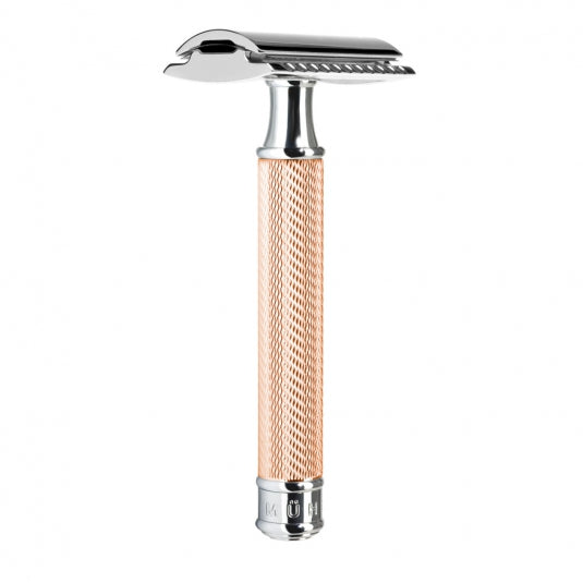 A rose gold chrome-plated, closed comb, safety razor with a textured handle.