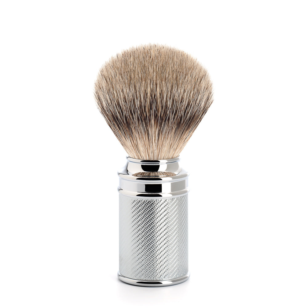 A chrome-plated metal shaving brush with silvertip badger hair, featuring a cylindrical shape with a cap and a horizontal black band through the bristles.